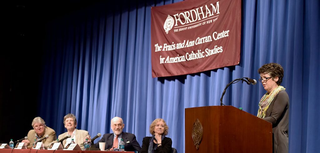 Alice McDermott addresses an audience at Pope Auditorium as fellow members of the panel discussion "Irish Incarnations of the Catholic Imagination" look on.