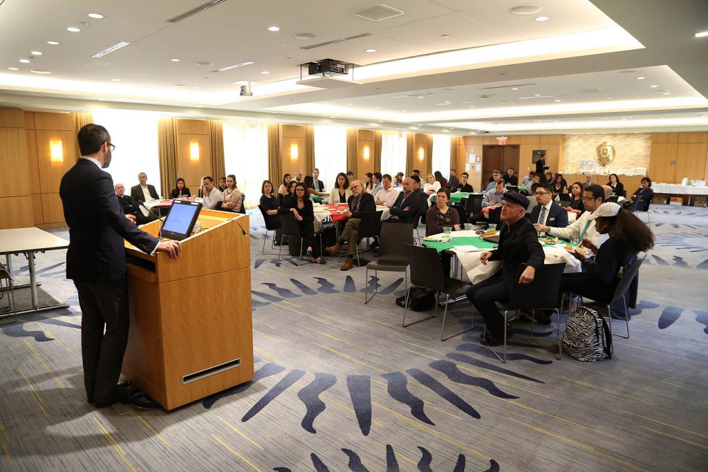 Ambassador Diego Gomez-Pickering, consul general of Mexico in New York, addresses the Fordham community from a podium on the Rose Hill campus