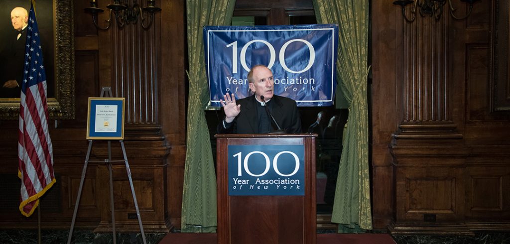 Joseph M. McShane, SJ, speaks from a podium at the University Club