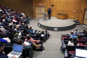 Howard Fuller speaking to students from the stage of McNally Amphitheatre