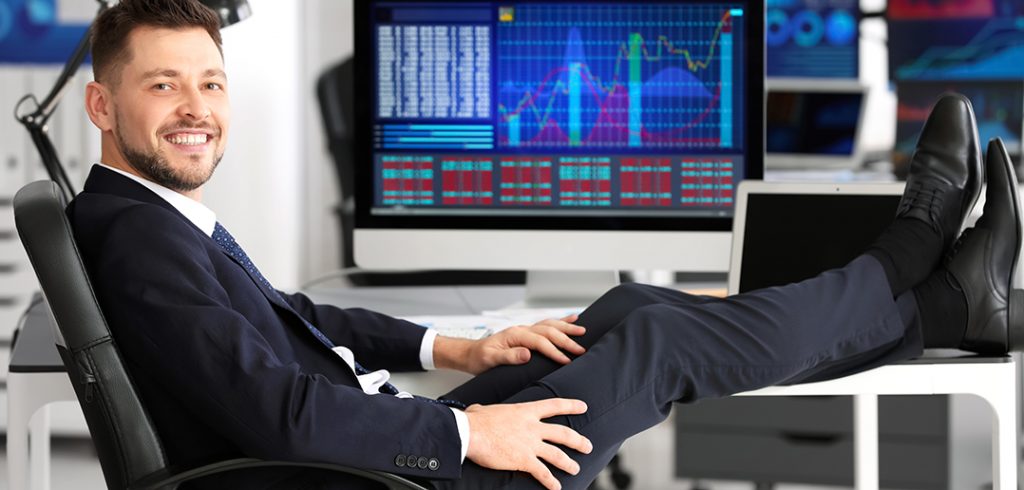 Stockbroker with feet up on desk