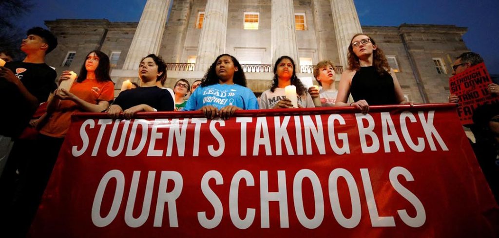 High school students hold candles in front of the North Carolina Capitol in Raleigh Feb. 20 in memory of the victims of the shooting at Marjory Stoneman Douglas High School in Parkland, Fla.