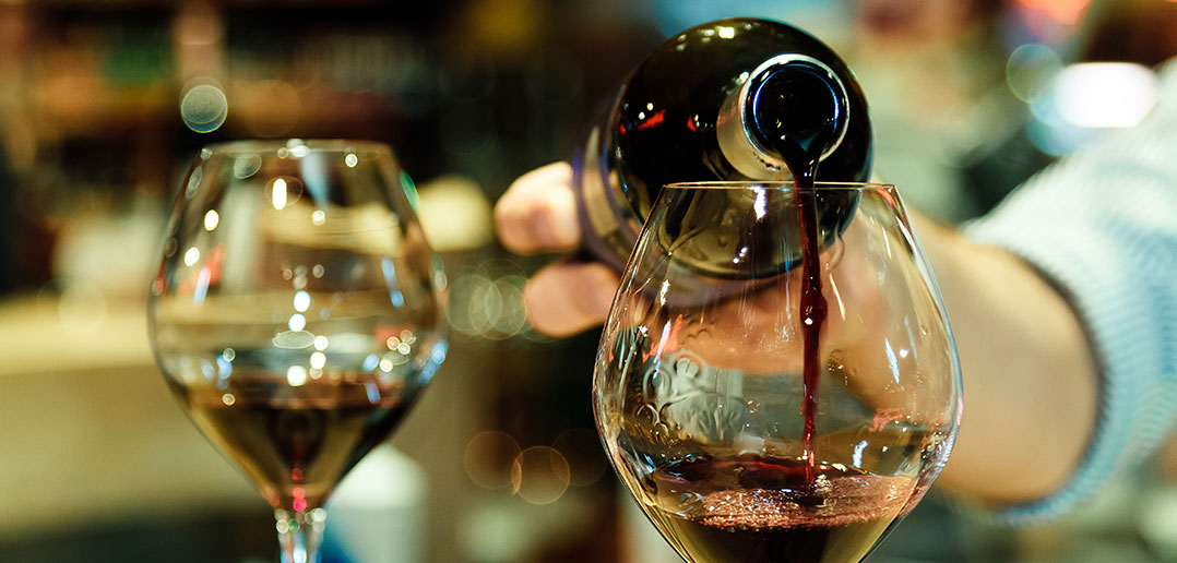 Sommelier pouring red wine