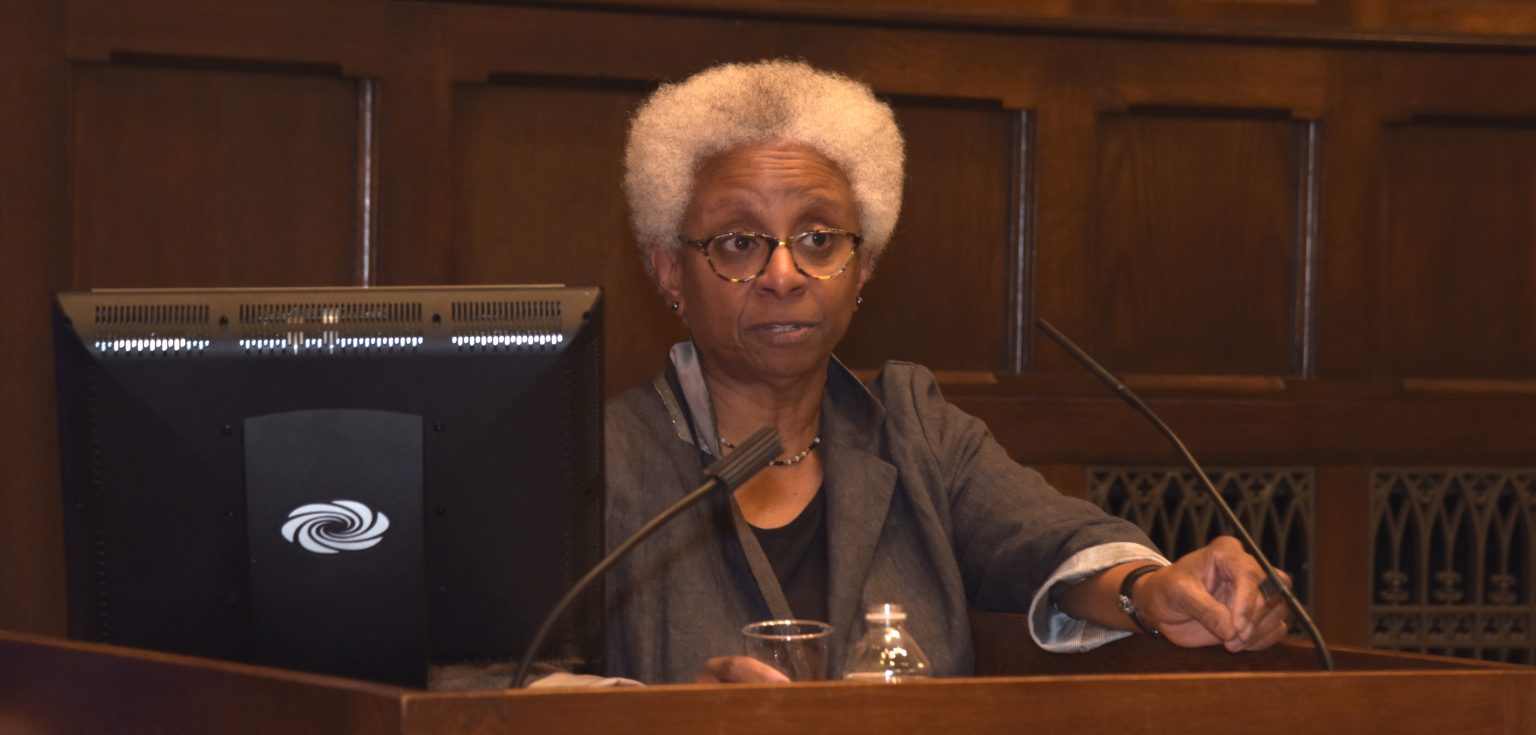 Mary Shawn Copeland speaks to the audience from a podium.