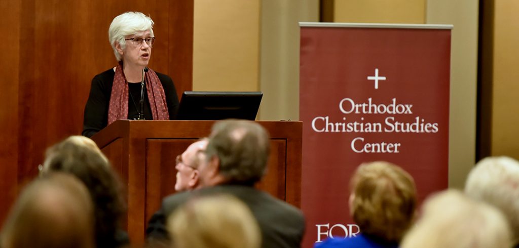 Helen C. Evans standing at a podium in the 12th floor lounge, at Fordham's Lincoln Center campus