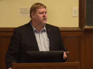 James Schmeling speaks from a podium.