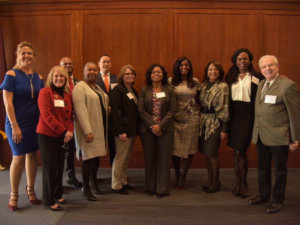 The keynote speaker, five panelists, and GSE faculty members stand together for a group picture.