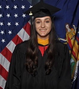 Rachel Ragone standing in front of an American flag 