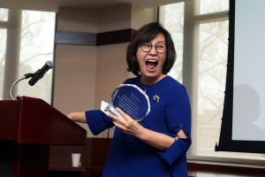 Su-Je Cho standing a a podium