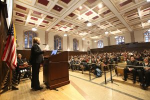 CRS Northeast Mid-Atlantic Regional Director Maureen McCullough, addresses the audience from the stage of Keating First auditorium