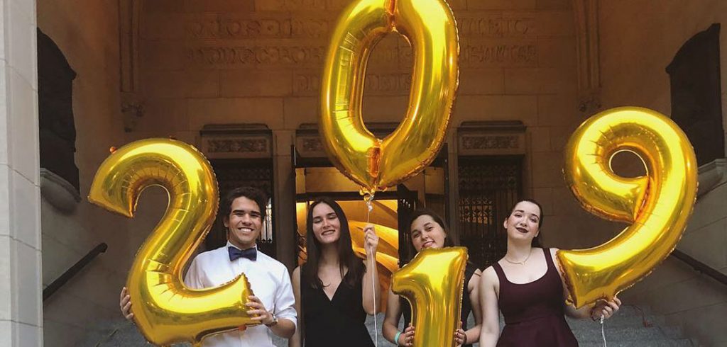 students holding balloons that say 2019