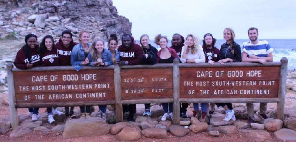 students stand behind a sign