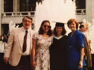 Four people standing in front of a fountain at Lincoln Center.