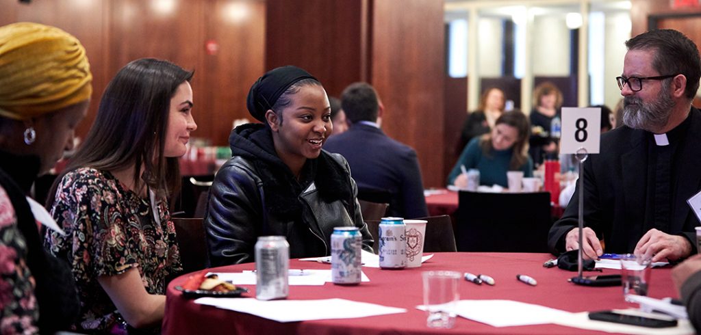 Father Mick McCarthy, at right, during a breakout session with students, community partners, and scholars