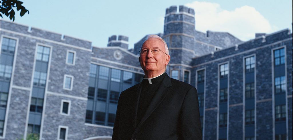 Father O'Hare in front of O'Hare Hall at Rose Hill