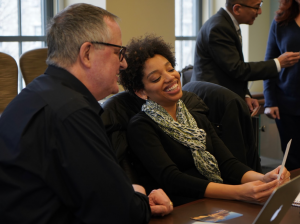 A man and a woman look at a card together.