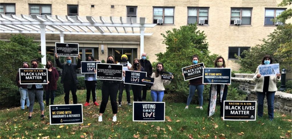 Students stand holding signs in support of social justice causes