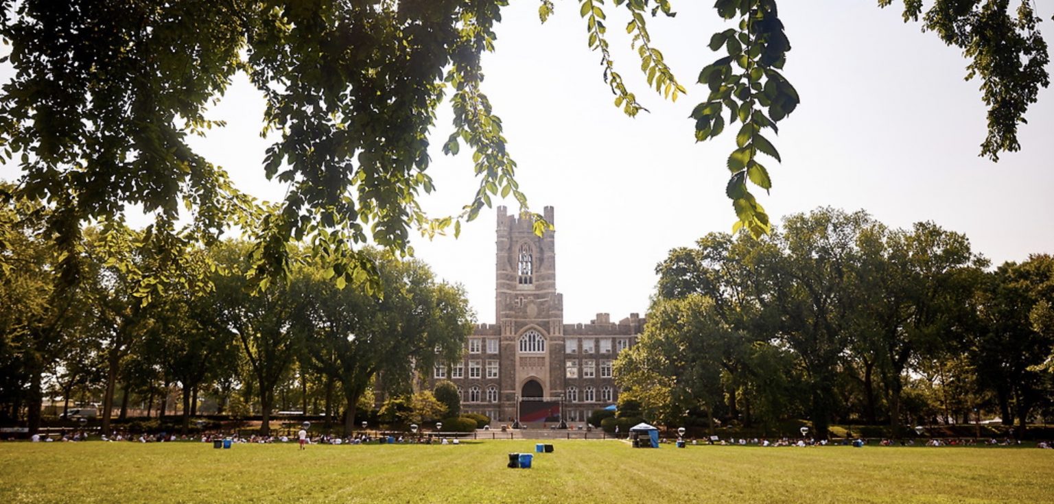 A large Gothic-style building surrounded by trees