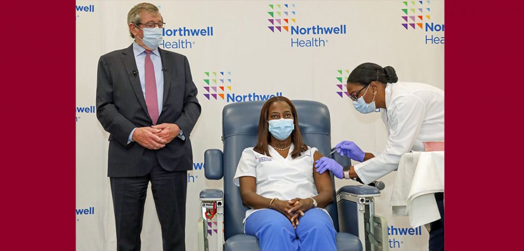 Michael Dowling stands by as nurse Sandra Lindsay receives the coronavirus vaccine