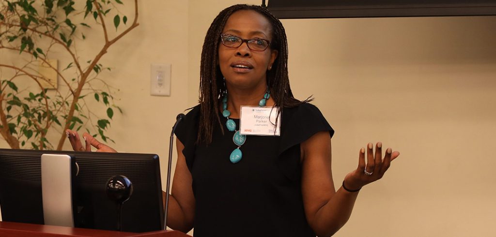 Marjorie Parker, FCRH ’90, stands a podium.