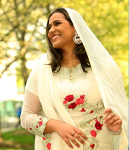 Senior Hafsana Sheikh wears a salwar kameez with a white dupatta. 