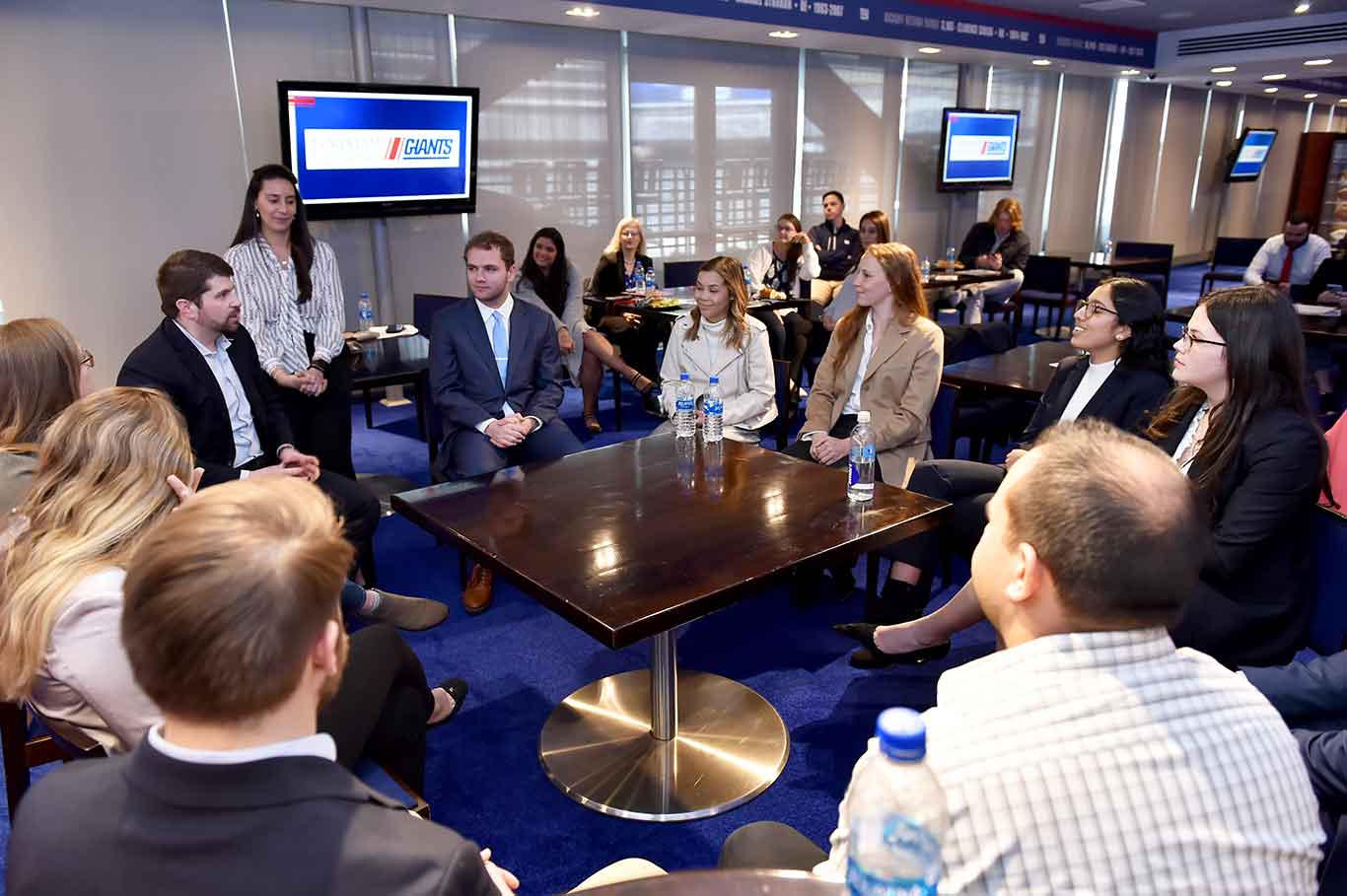 students and employees of the Giants sitting around a table