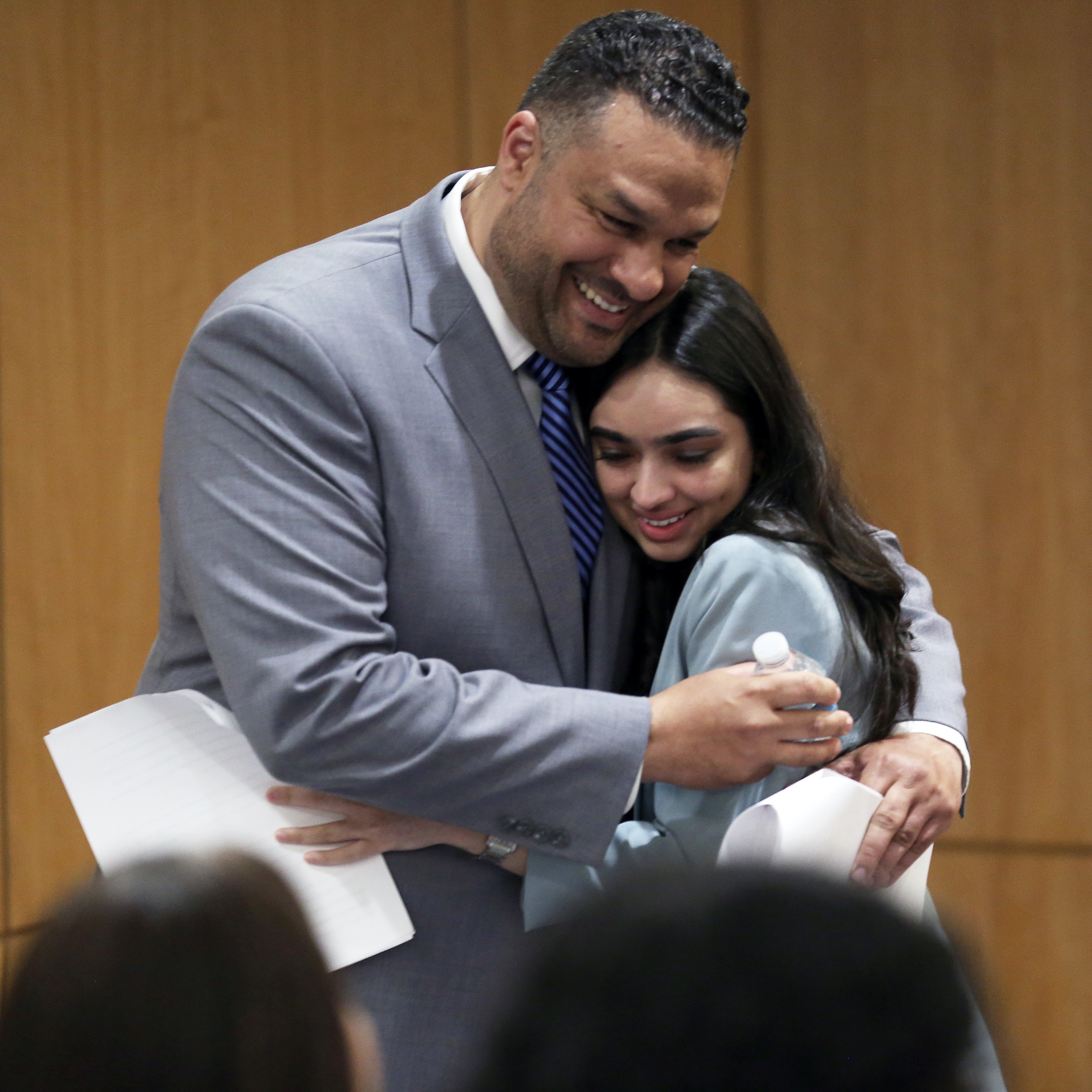 A man and a woman embrace.