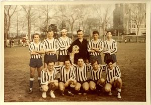 Leo Hoar standing with a group of soccer players on Edwards Parade