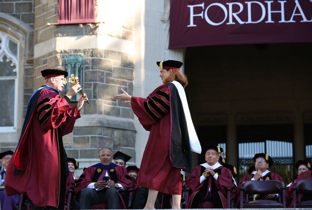 Father McShane gives the ceremonial mace to Tania Tetlow