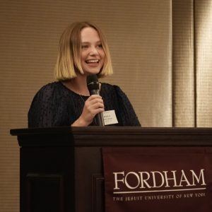 A woman speaks at a podium.