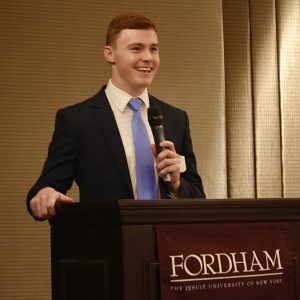 A man speaks at a podium.