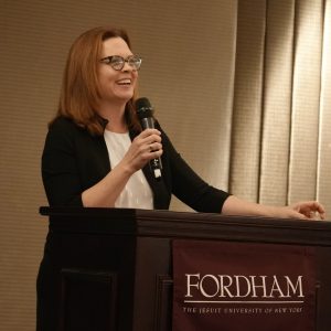 A woman speaks at a podium.