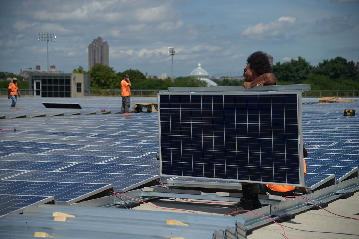 A man carries a solar panel