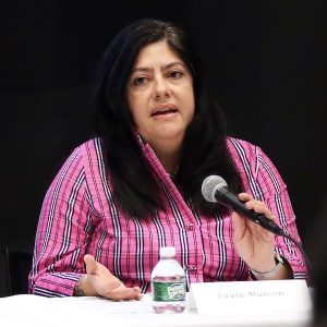 A woman speaks into a microphone.