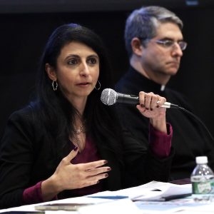 A woman speaks into a microphone.