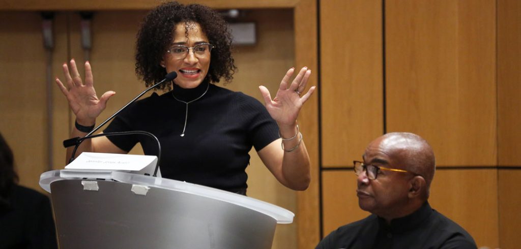 A woman talks at a podium