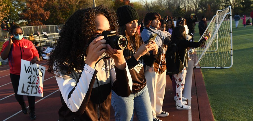 A girl poses with a camera