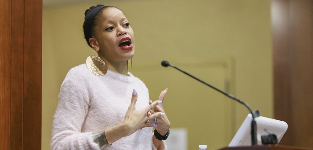 Khiara M. Bridfes speaking with mic in front of her