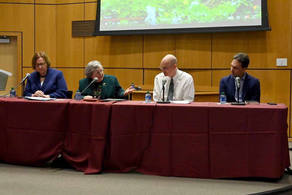 Christine Firer Hinze, Elizabeth Johnson, Jason Morris and Michael Pirson seated together at a table on stage.