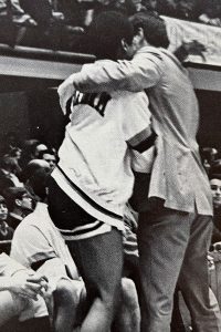 Digger Phelps hugging a player.