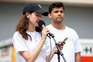 Sophia Maier stands in front of a microphone