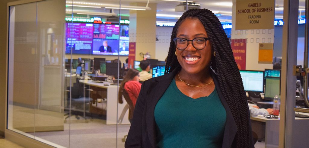 Young woman in front of trading room at Gabelli