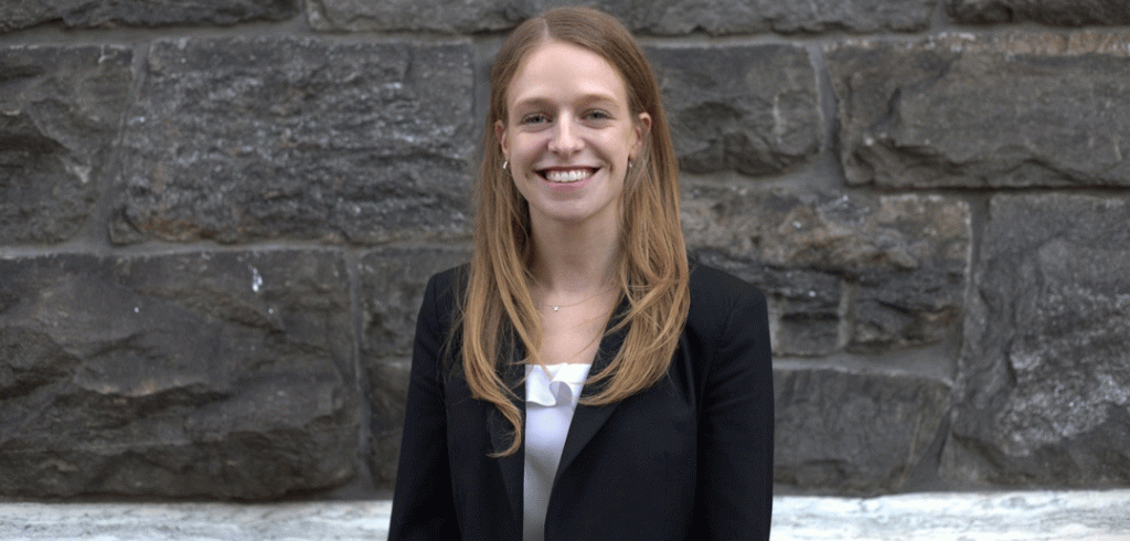 Lois van Weringh, posing outside a building with a black blazer on.