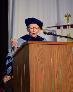 A woman speaks from a podium