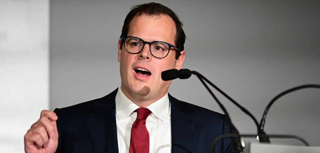 A man speaks at a podium