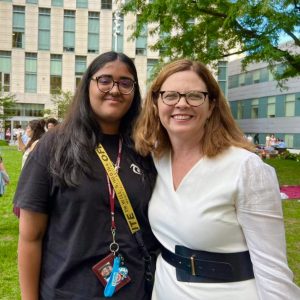 Preeti Lamba and President Tetlow smile at the Lincoln Center campus plaza.