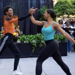 Two students dance together.