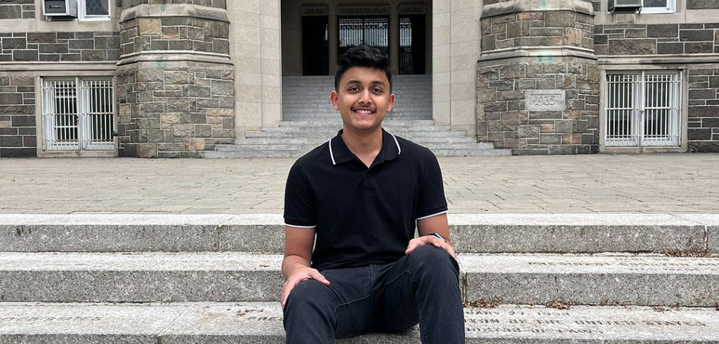 A student sits on the stairs