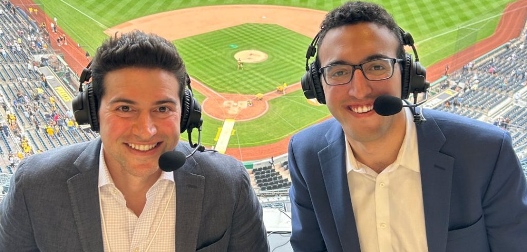 Two people in a broadcast booth