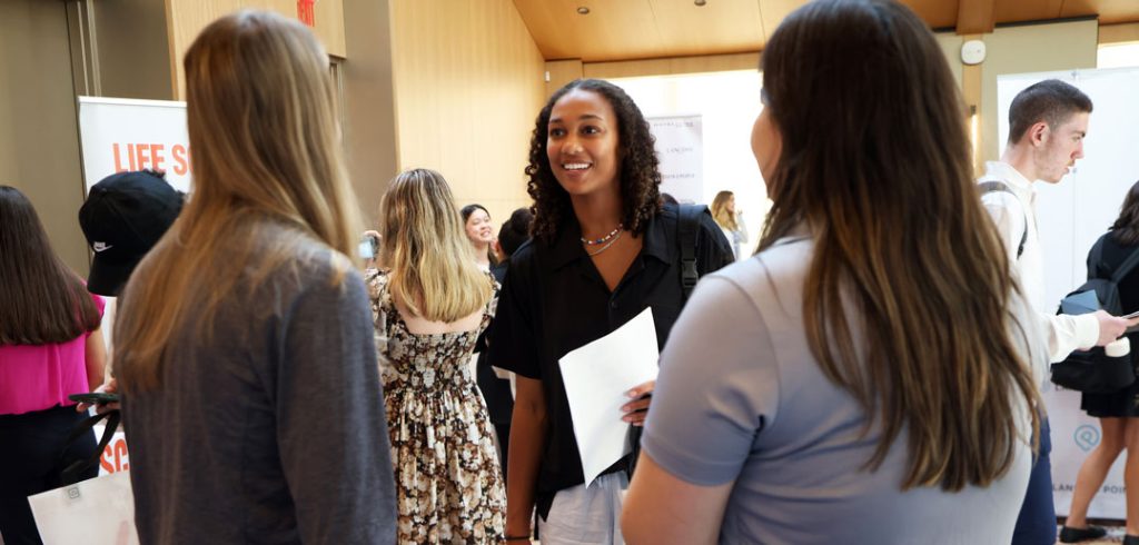 Students meet with employers at internship fair.